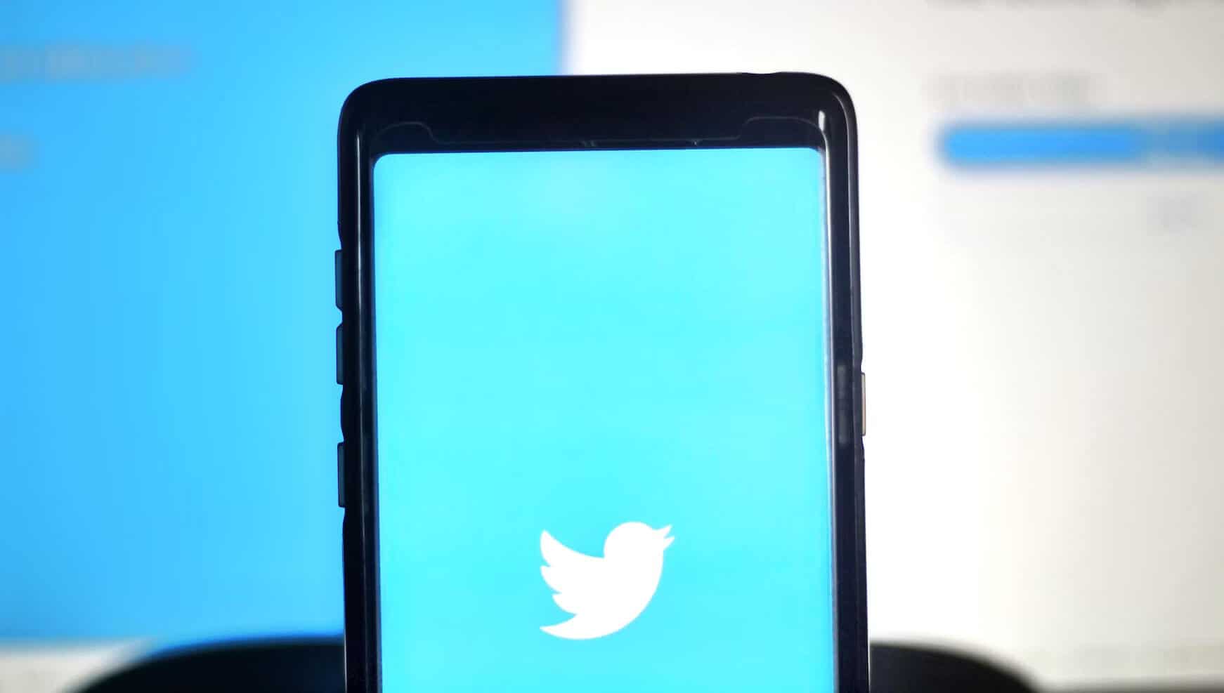 Black smartphone displaying Twitter logo